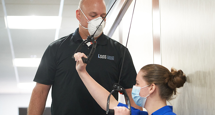 post surgery physical therapy near syracuse ny image of physical therapist and patient doing exercises