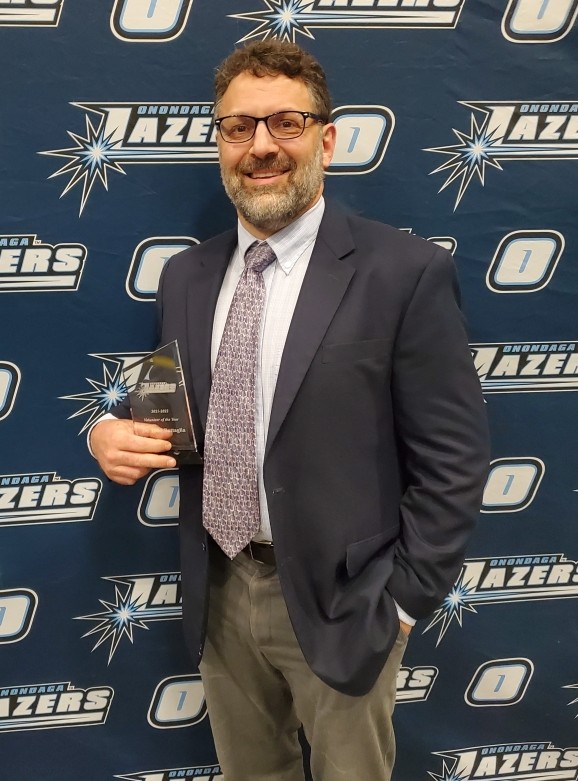 Dr. Todd Battaglia Accepting Volunteer of the Year Award at Onondaga Community College Athletics Banquet in May 2022