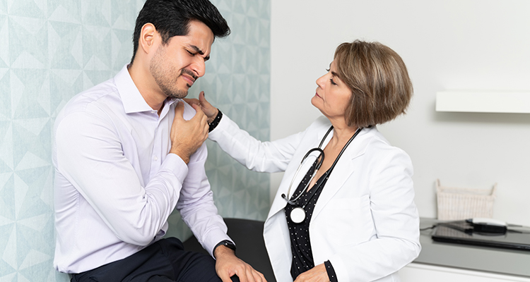 shoulder replacement surgery near watertown ny image of man with shoulder pain and doctor touching shoulder