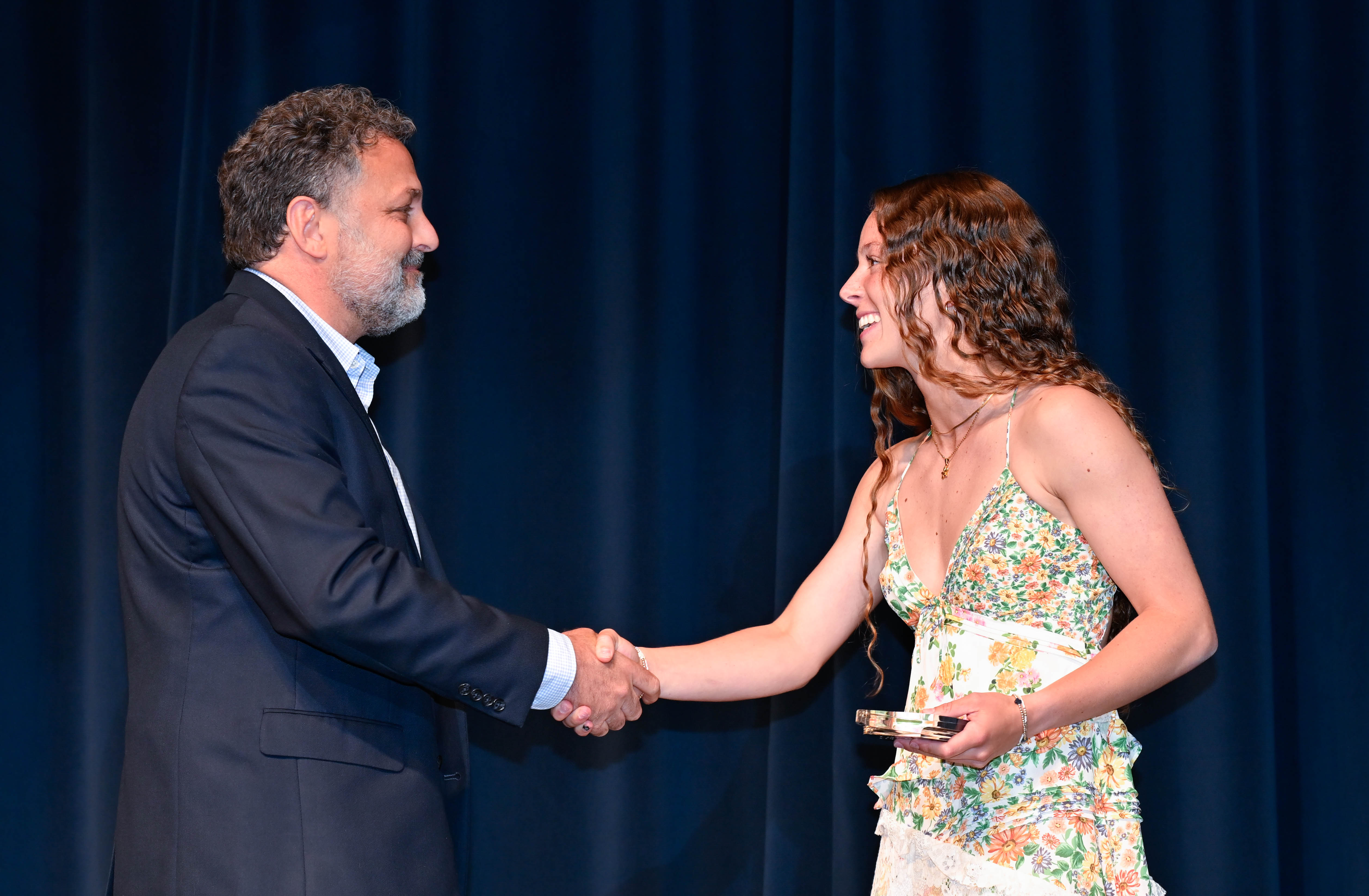Dr. Todd Battaglia shaking hands with Cece Powell CNY top female athlete of the year