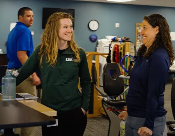 syracuse physical therapy and occupational therapy patient looking excited while talking to physical therapist