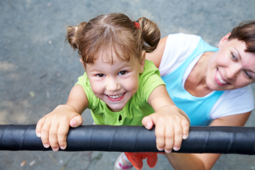 Playground Saftey_ girl on monkey bars