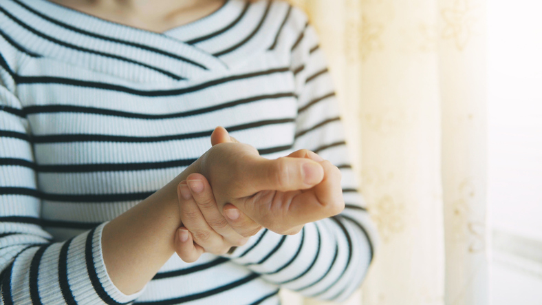 Twisting Wrist Pain Woman holding Wrist