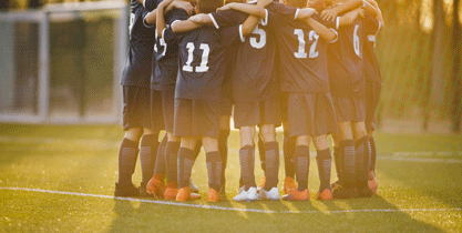 soccer players getting ready for the game together on the field 